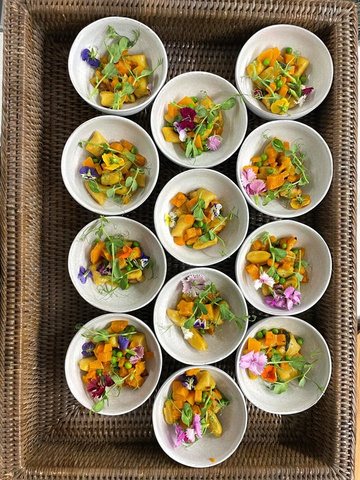 A tray of identical individual portions, each garnished the same way.